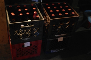 Some milk crates performing one of their many functions in the home brewery, holding two batches of freshly bottled brew!
